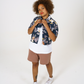 Upcycled womens Navy Floral Viscose Shirt with cropped hem, styled over a white t-shirt and paired with our cinnamon jersey shorts. 