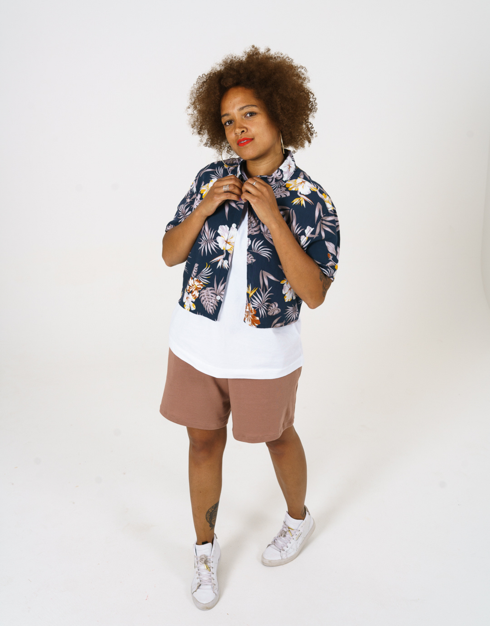 Upcycled womens Navy Floral Viscose Shirt with cropped hem, styled over a white t-shirt and paired with our cinnamon jersey shorts. 