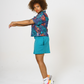 Digital Printed Cotton womens shirt, in bright teal and orange leaf print, paired with our teal Jersey shorts and styles with Bright trainers and socks. 