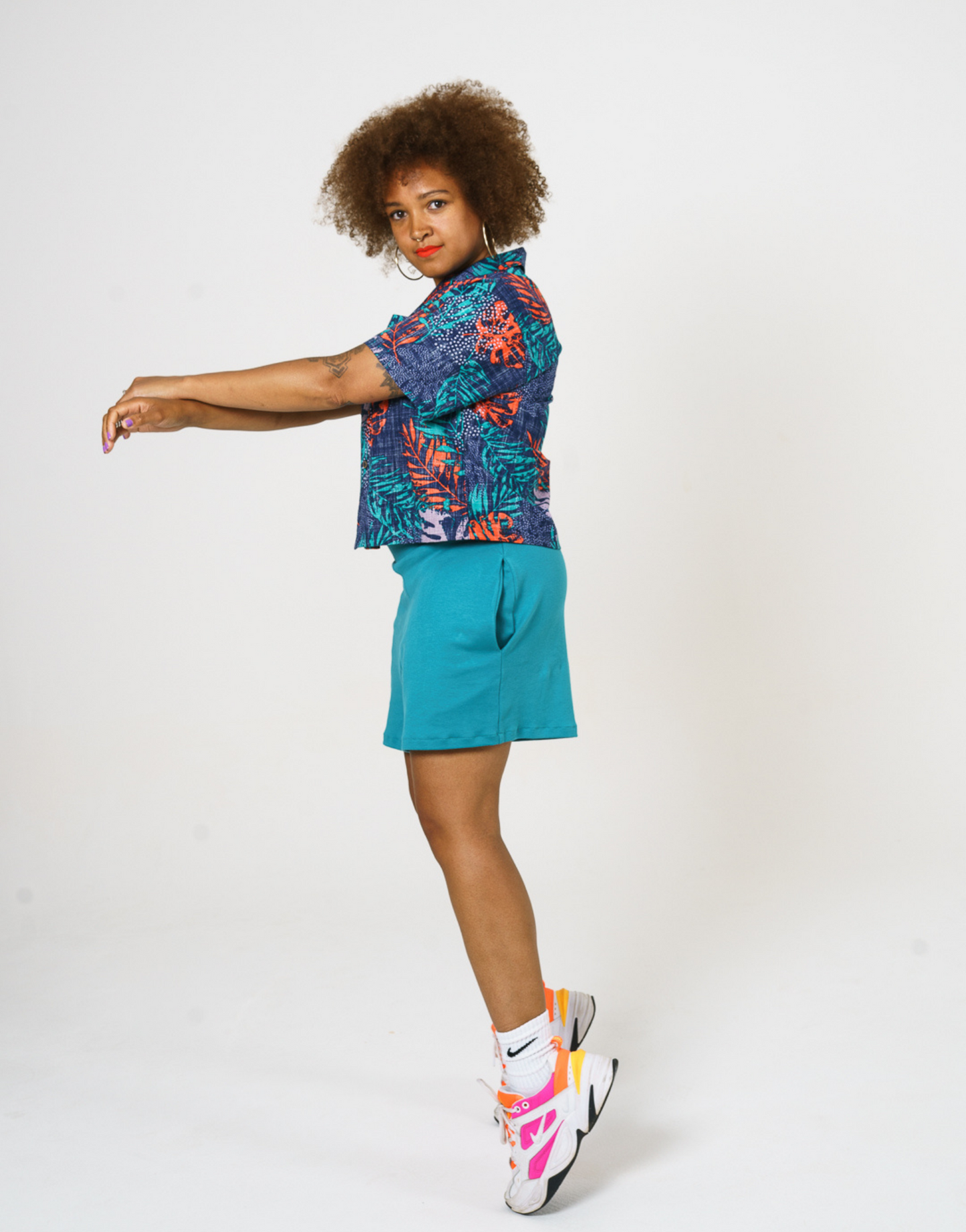 Digital Printed Cotton womens shirt, in bright teal and orange leaf print, paired with our teal Jersey shorts and styles with Bright trainers and socks. 