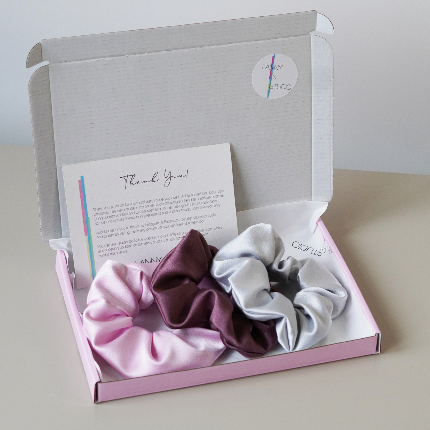 Pink, purple and Silver Satin scrunchies in pink gift box with branded tissue paper and personalised note.