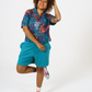 Digital Printed Cotton womens shirt, in bright teal and orange leaf print, paired with our longer length teal Jersey shorts and styles with Bright trainers and socks. 