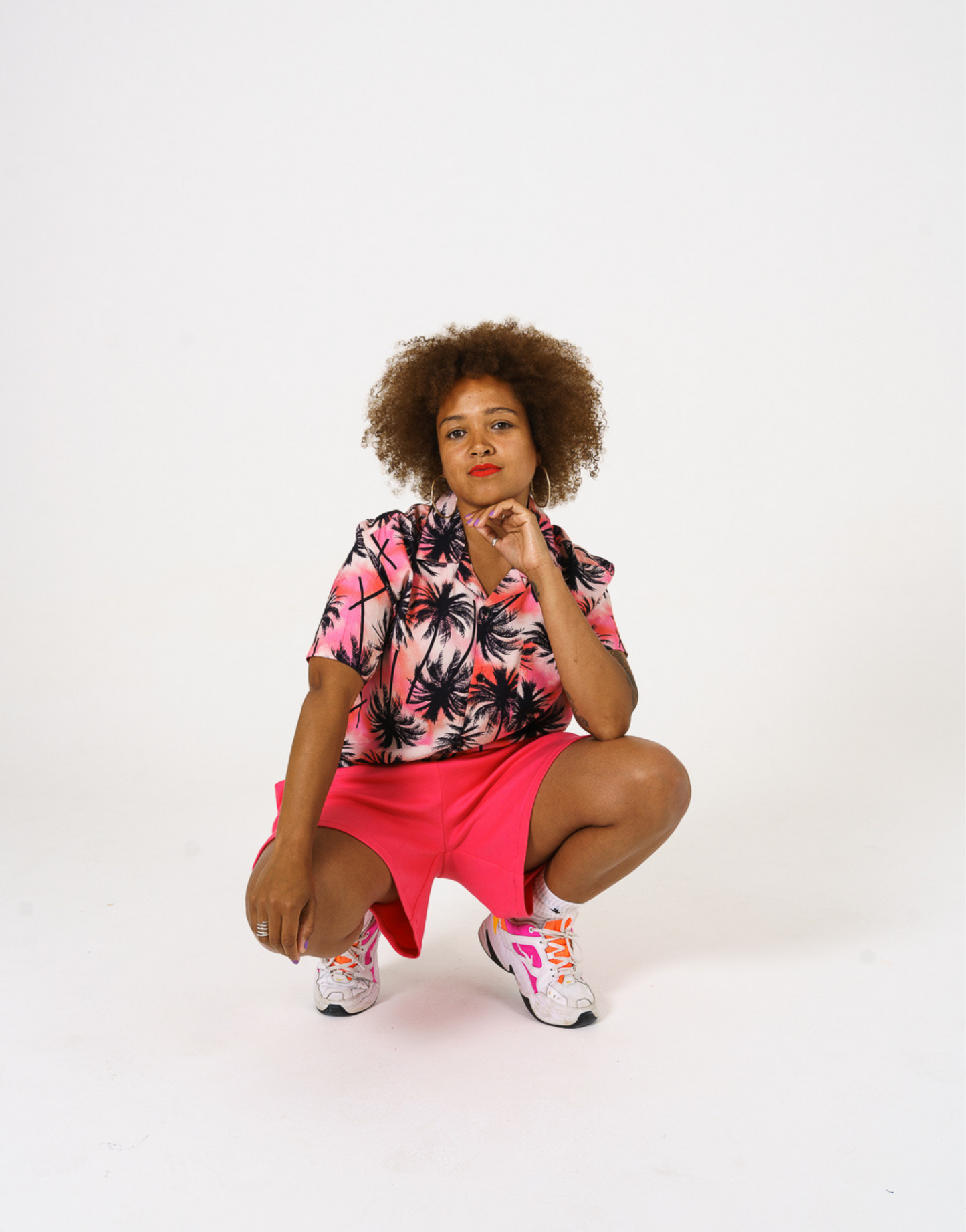Bright pink Tye dye printed women shirt with black palms paired with our bright pink jersey shorts. Style closed with bright neon trainers and socks. 