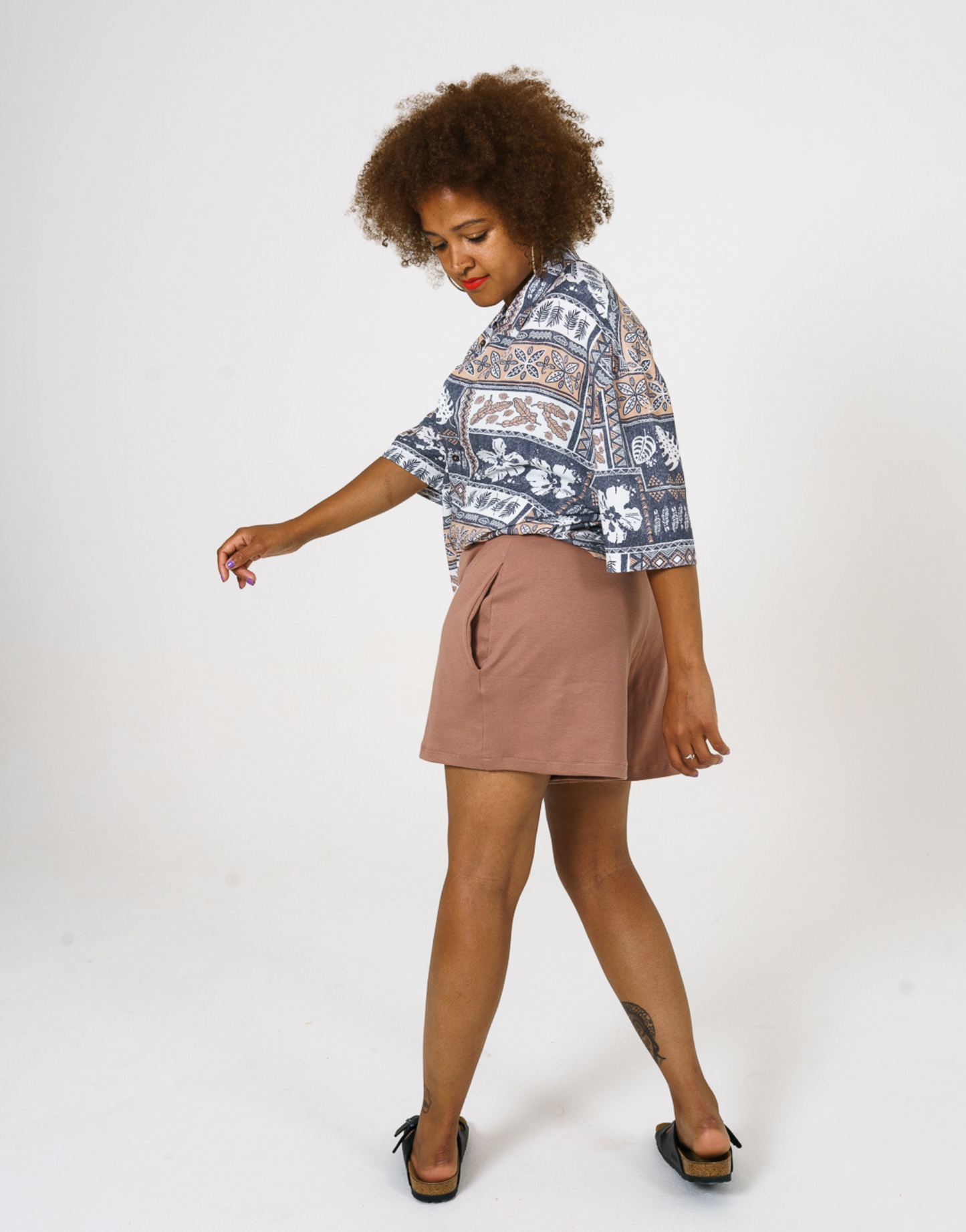 Side view of our relaxed fit aztec inspired printed women shirt, paired with our cinnamon Jersey shorts.