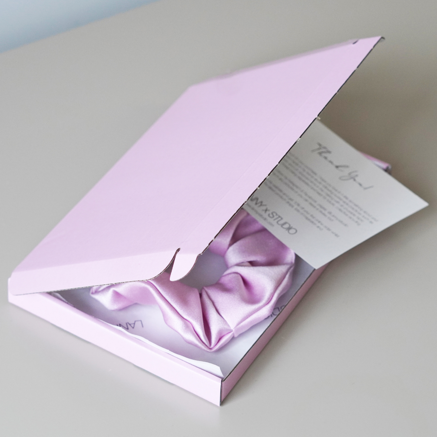 Pink gift box with pink satin scrunchie. 